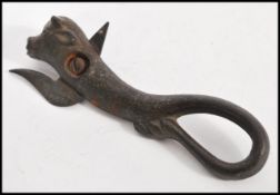 A vintage 19th Century cast metal Bully tin opener, the body modelled as a bull, the blade