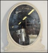 A 19th Century Victorian painted framed oval mantel mirror, with bevelled glass plate, surmounted by