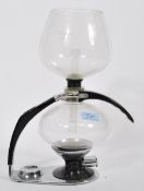 A vintage retro 20th century Cona coffee machine having glass bowl with black and chrome mounts.