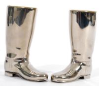 A pair of 20th Century silver plated drinks measures in the form of riding boots having raised