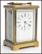 A circa 1900 French lacquered brass carriage clock, the enamel dial with Roman numerals chapter