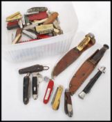 A collection of vintage and retro hunting knives, pen knives to include Swiss Army, military