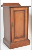 An Edwardian mahogany pot cupboard being raised on plinth base with locker door and gallery top