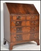 An 20th century Georgian Revival reproduction mahogany bureau bookcase having a fall front with