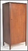 A mid century teak wood upright sentry box bachelors wardrobe with squared legs having full length