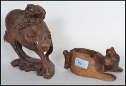 Two early 20th century carved Chinese wooden figurines to include an ox on plinth base with man