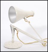 A vintage retro mid 20th century Herbert Terry industrial anglepoise lamp raised on circular base