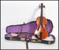 An early 20th century French Le Parisien quarter violin having ebony tuning pegs. In fitted case.