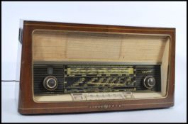 A vintage early 20th century Truxa Loewe Opta oak cased radio with glass dial front and grille. 30 H