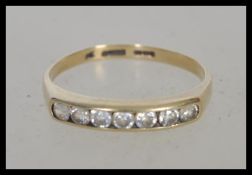 A 9ct gold ring stamped 375 having channel inset with stones to the head. Weight 1.6g. Size P.5.