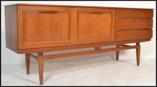 A retro 20th Century teak sideboard / credenza of Danish inspiration, having a run of three