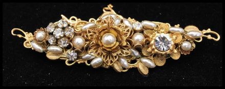 A signed  1950s Miriam Haskell Frank Hess gold-tone brooch having metal findings filigree work, faux