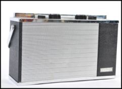 A DISCATRON PORTABLE 7' RECORD PLAYER, pressed chromium and plastic within a black leatherette carry