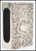 A 19th century Victorian hallmarked silver matchbox cover having embossed decoration of scrolls