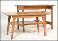 A 1970's teak wood rectangular coffee table with squared legs united by stretchers together with