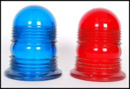 A pair of vintage coloured glass police siren light covers in blue and red. 12cm high 10cm diameter.
