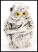 A silver plated vesta in the form of a monkey having yellow and black glass eyes and a hinged head