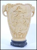 A 20th Century Chinese composite carved vase depicting a detailed landscape scenes with ladies in