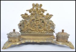 A 19th century Victorian large brass desk tidy twin capstan inkwell holder with pen tray. Scrolled