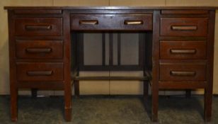 A vintage mid 20th century oak air ministry industrial twin pedestal desk having an arrangement of