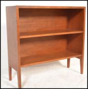 A retro 20th Century Danish influenced teak wood open bookcase, having a single adjustable shelf