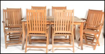 A large good quality garden patio teak dining table and chairs suite from the Chilworth