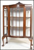 An early 20th century 1920's mahogany china display cabinet / bookcase having claw and ball feet