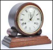 An early 20th century Edwardian Comitti Of London mahogany cased mantle bracket clock. Raised on