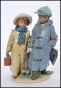 A Lladro model of two children walking hand in hand in winter clothes, inscribed no.2242 to the