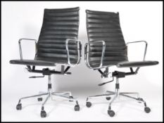 After Charles & Ray Eames - EA 119 - Aluminium group - A pair of Vitra type swivel desk chairs