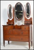 An early 20th century Edwardian mahogany inlaid dressing table desk raised on tapering block legs