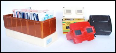 A group of vintage View master slide viewers and slides to include boxed French Bakelite example,