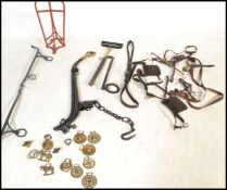 A selection of equestrian / horse riding related items including a wall mounted saddle rack, a