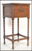 An early 20th Century Edwardian oak tall oak pot cupboard, the flared top with fall front flap
