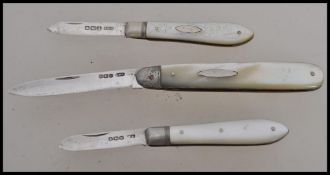 A group of three silver hallmarked and mother of pearl handled fruit pen knives. One hallmarked