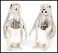 A pair of stamped 800 silver condiments / salt and pepper shakers in the form of penguins having
