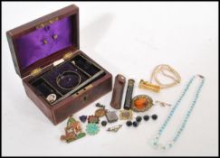 A collection of vintage costume jewellery dating from the early 20th Century housed within a 19th