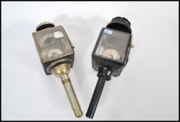 Two early 20th century Edwardian carriage lamps of typical form having ebonised bodies with bevelled