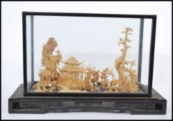 A large 20th century Japanese cork diorama model of a traditional Japanese scene with pagodas, trees