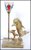An unusual vintage seahorse and dolphin lamp of brass construction having a relief brass scene