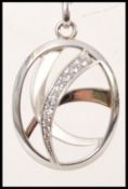 A stamped 925 silver pendant necklace having a oval shaped pendant with inset cz's,. Weight 12.9g.