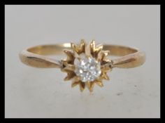 A stamped 9ct gold ring set with a brilliant cut with stone in a star setting. Weight 1.5g. Size J.