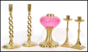 Two pairs of 19th / 20th Century brass candle sticks, the larger having a dual spiral stem raised on