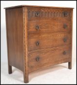 A Jaycee medium oak chest of four graduating drawers, flared top raised on stile supports. Measure: