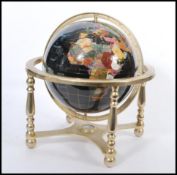 A vintage 20th century large terrestrial globe having semi precious stone inlay. Black stone