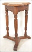 A 19th century Victorian Arts & Crafts oak lamp table having turned tapering legs with splayed
