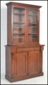 A Victorian 19th century mahogany library bookcase cabinet. Raised on a plinth base with double door