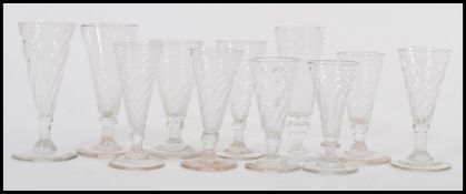 A selection of 19th Century Victorian tall glasses having spiral detailing to the trumpet form