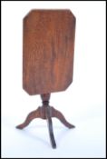 A 19th Century miniature large scale dolls house mahogany tilt top table raised on a central