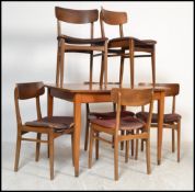 A vintage mid 20th Century teak wood extending Danish influence dining room suite comprising a